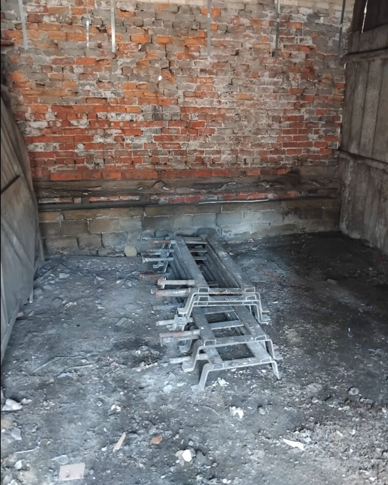 The same outbuilding, emptied down to a bare floor