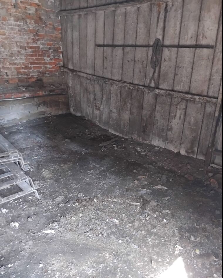 The same corner, cleared back to the timber wall