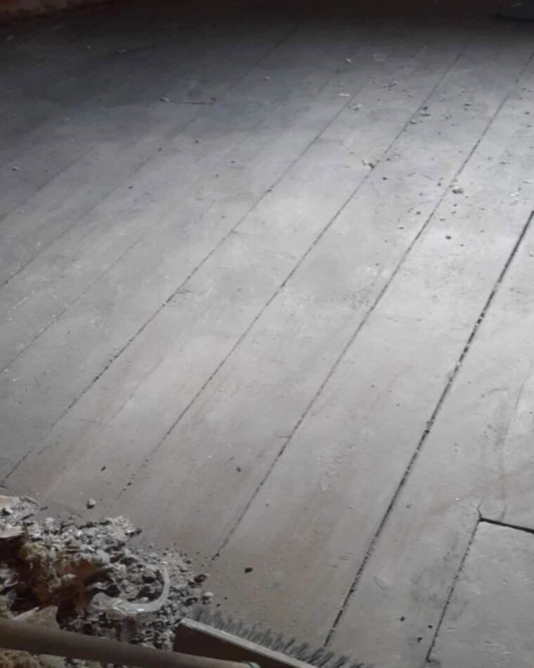 The same loft cleared down to bare floorboards
