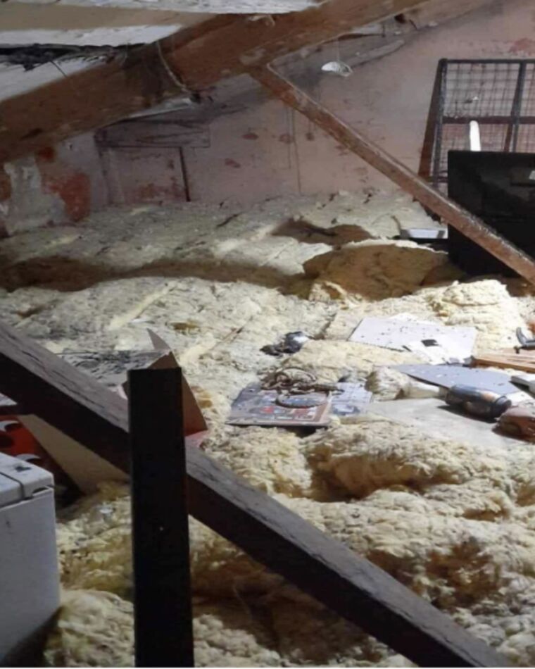 A loft full of old insulation, boxes and stored junk