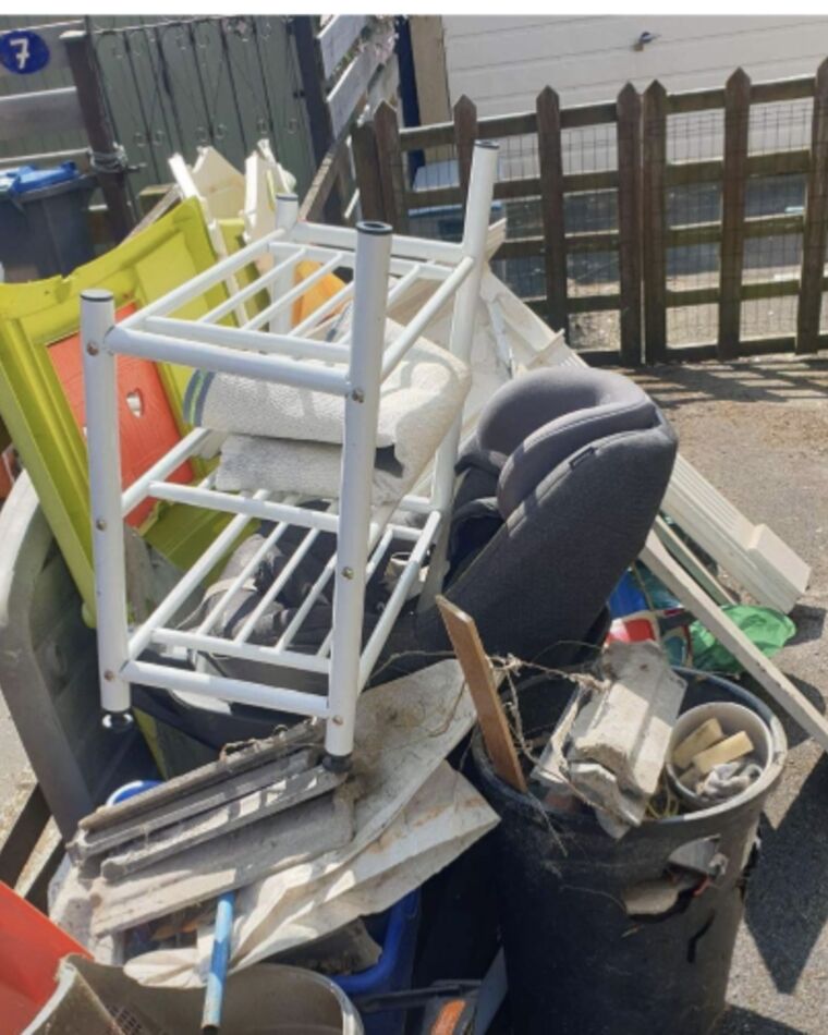 A bin yard blocked by bulky household waste
